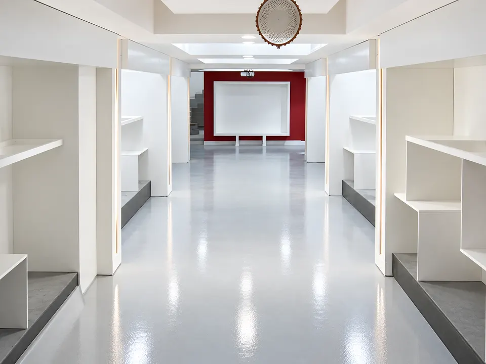 Light grey seamless floor in clean corridor/service interior