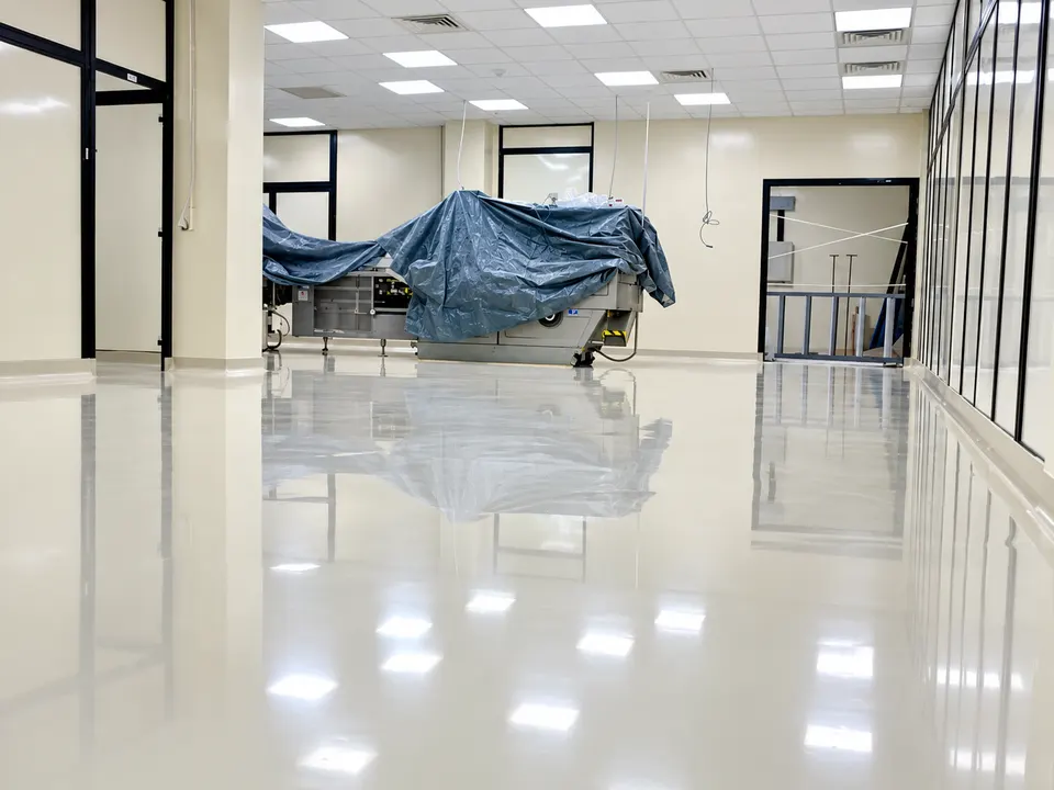 Light grey/white seamless floor in clinical/technical interior